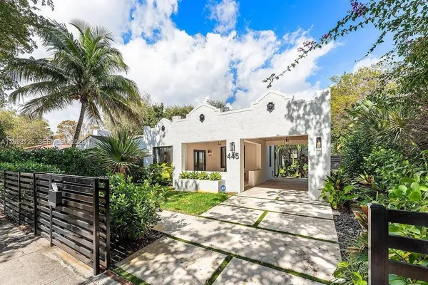a front view of a house with garden