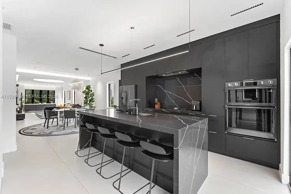 a bedroom with a large bed and a flat screen tv