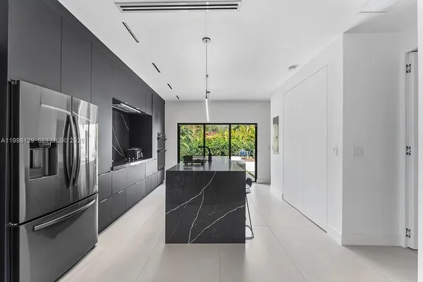 a bathroom with a tub shower and mirror