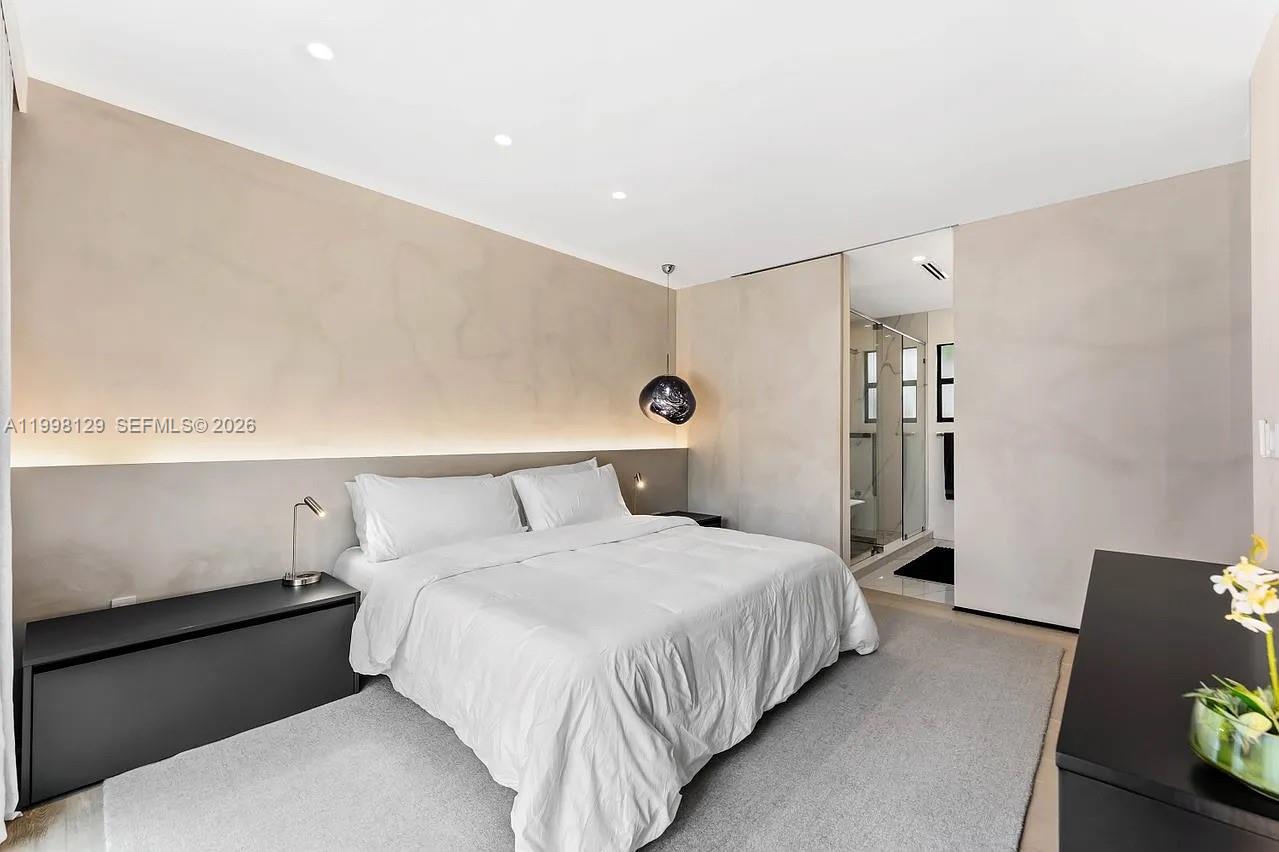 445 Northeast 76th Street Miami, FL 33138 - Photo 28 of 63 a bedroom with a bed and wooden floor
