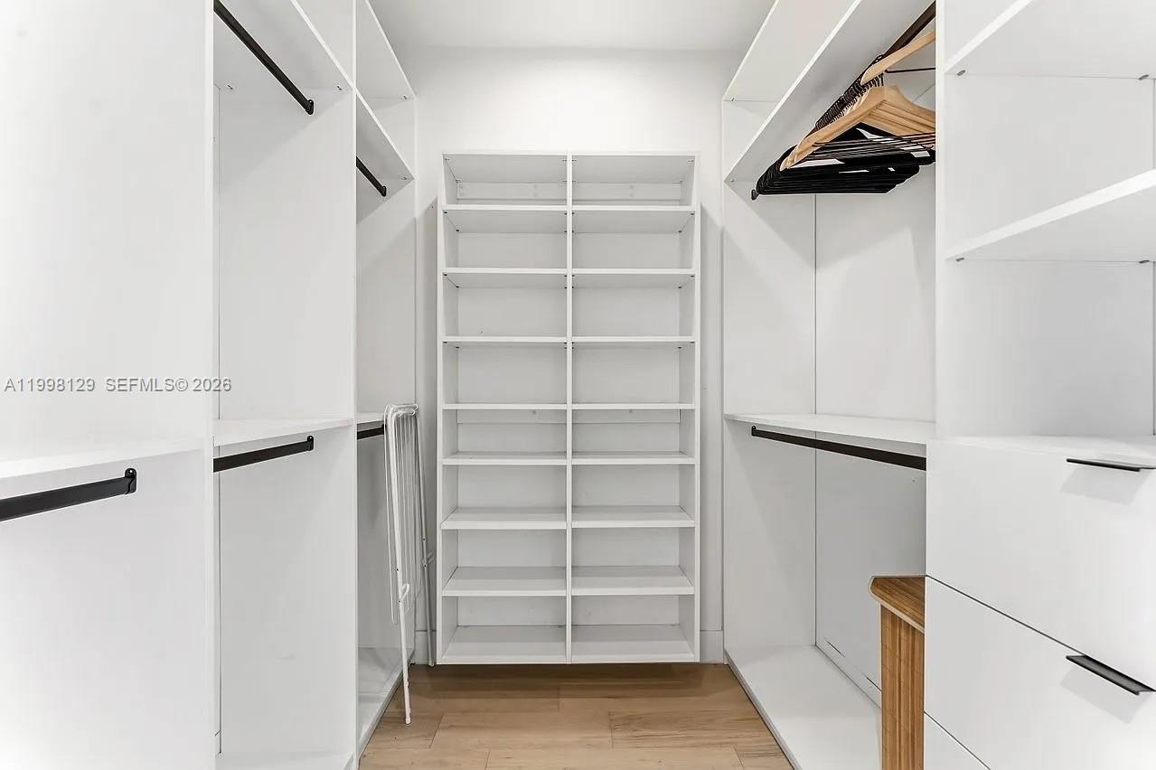 445 Northeast 76th Street Miami, FL 33138 - Photo 30 of 63 a view of walk in closet with empty racks