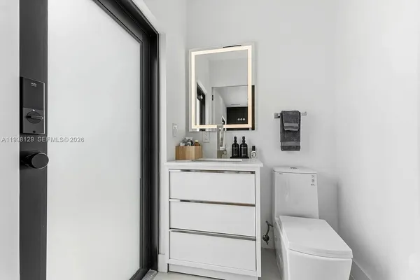 a open kitchen with stainless steel appliances kitchen island granite countertop a table and chairs in it