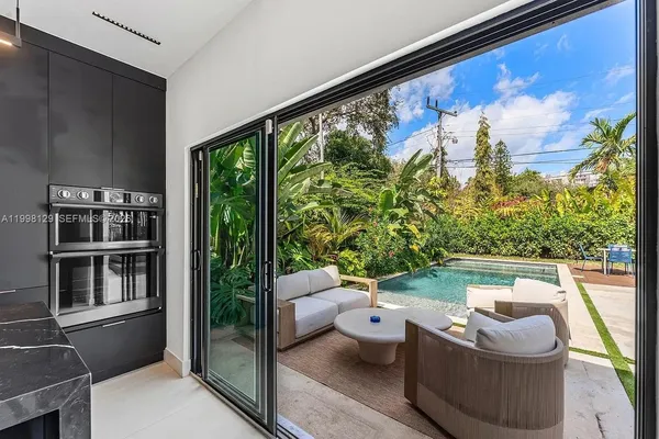 a kitchen with a refrigerator sink and cabinets