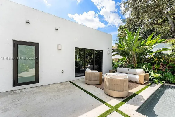 a living room with furniture and a kitchen