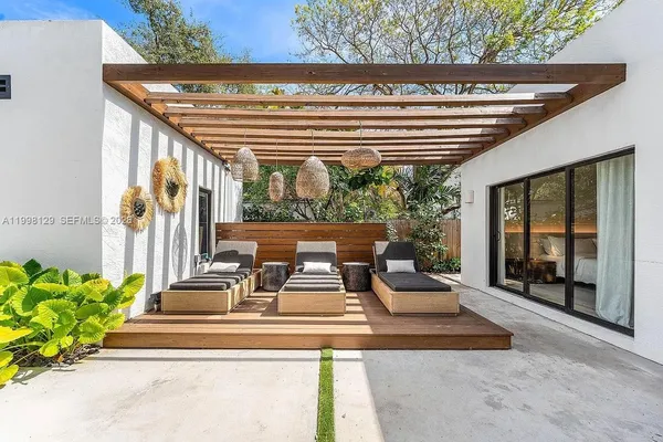 a view of a backyard with sitting area