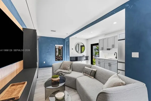 a view of house with swimming pool and sitting area