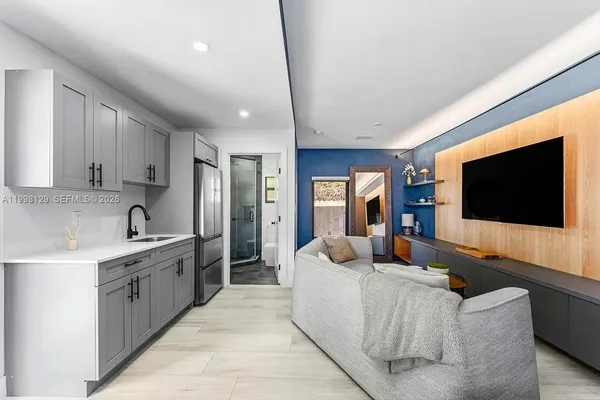 a view of a house with a yard and potted plants