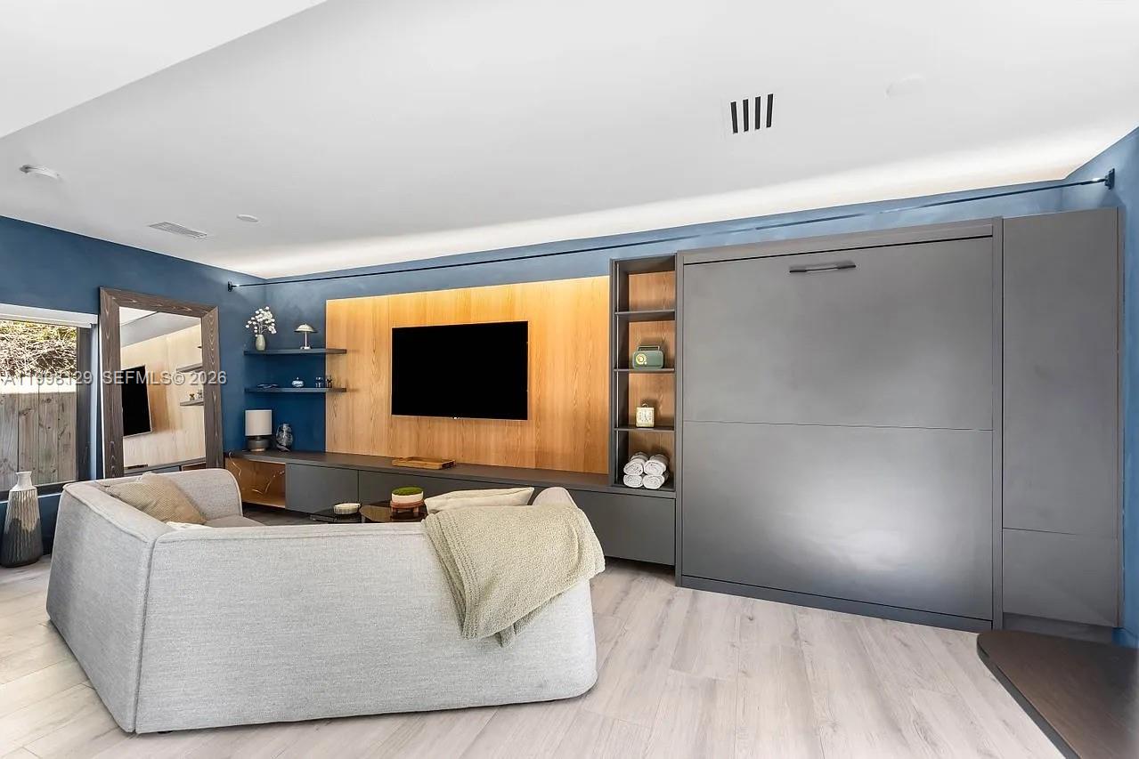 445 Northeast 76th Street Miami, FL 33138 - Photo 50 of 63 a living room with furniture and a flat screen tv