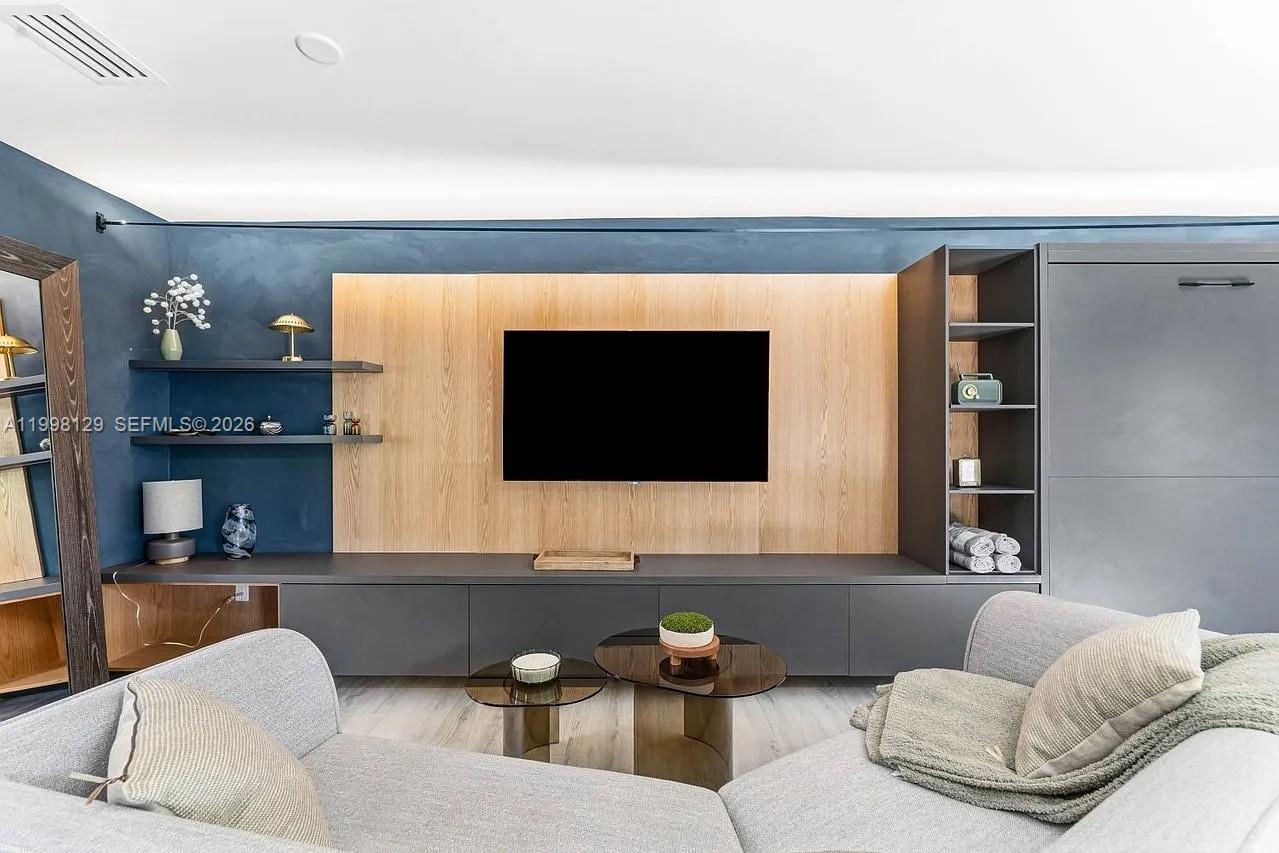 445 Northeast 76th Street Miami, FL 33138 - Photo 51 of 63 a living room with furniture and a flat screen tv
