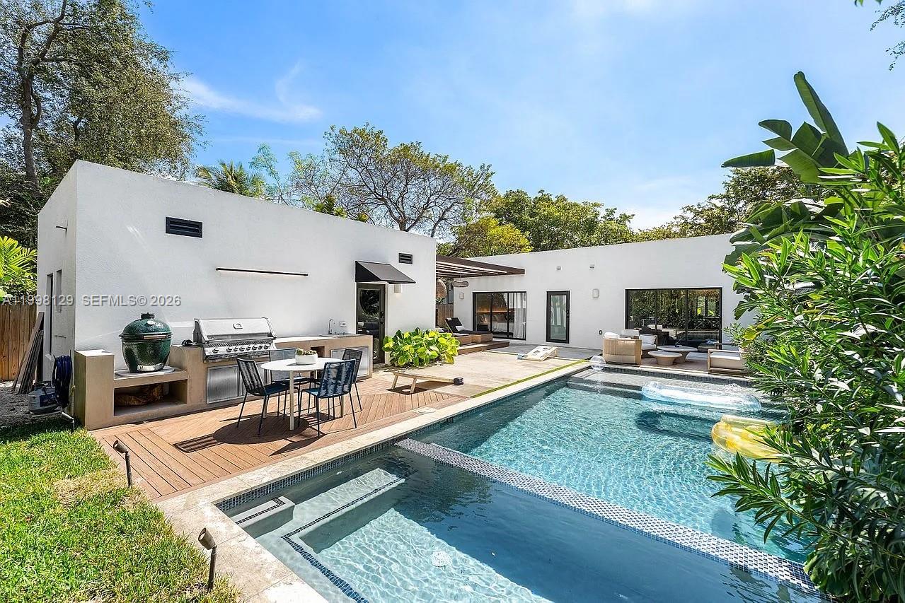 445 Northeast 76th Street Miami, FL 33138 - Photo 54 of 63 a view of a backyard with table and chairs