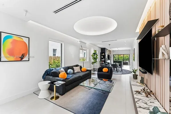 a dining room with furniture a rug and a chandelier