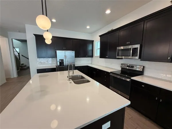 a kitchen with a sink cabinets and stainless steel appliances