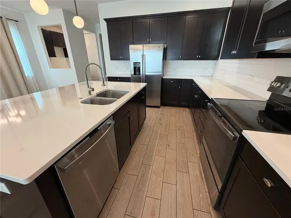 a kitchen with a sink and a stove top oven