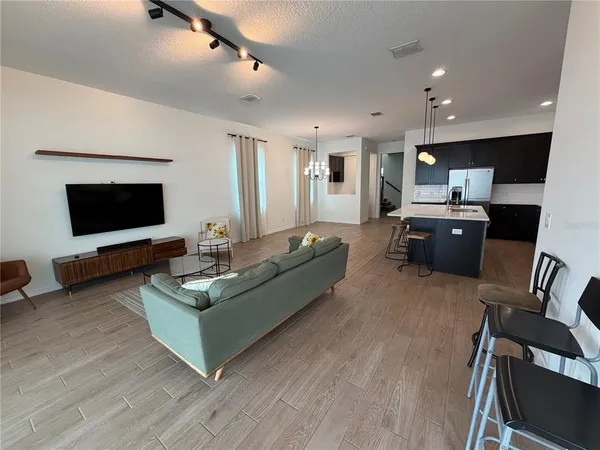 a living room with furniture flat screen tv and a fireplace