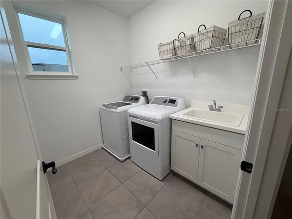 a utility room with a sink dryer and washer