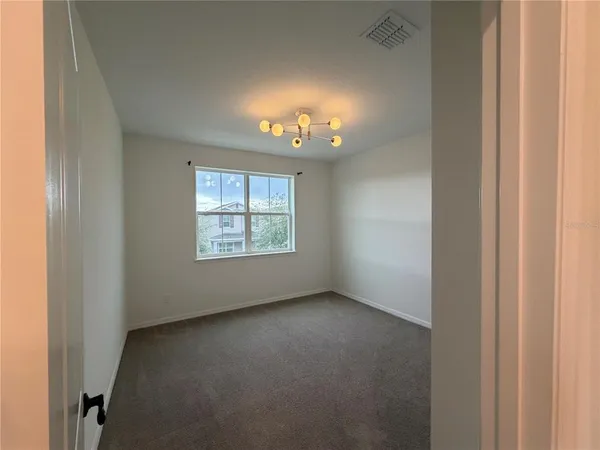 an empty room with windows and closet