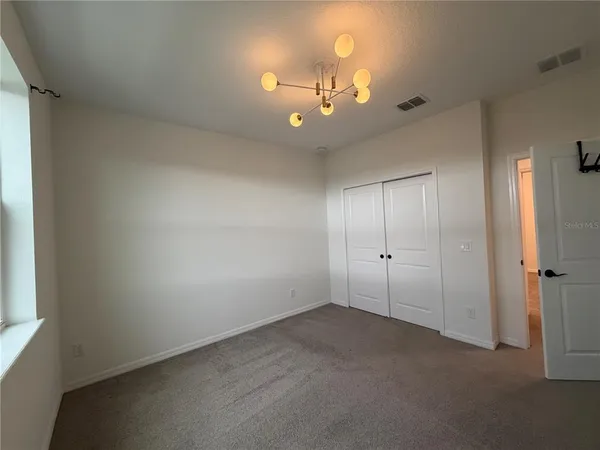 a view of a livingroom with a ceiling fan and window