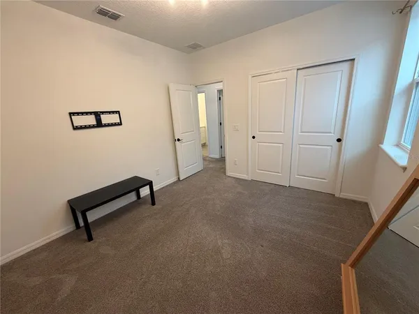 a bathroom with a double vanity sink and mirror with toilet