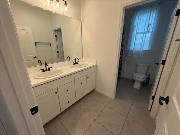 a bathroom with a toilet and a shower curtain