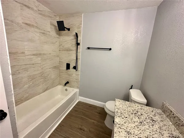 a bathroom with a bathtub and shower