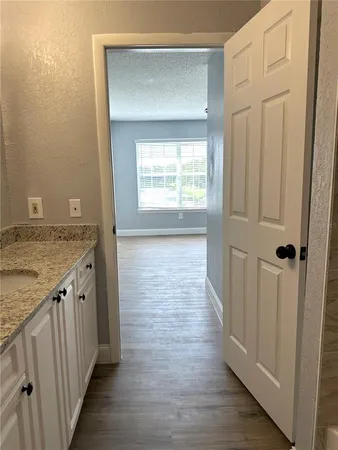 a view of a kitchen cabinets and wooden floor