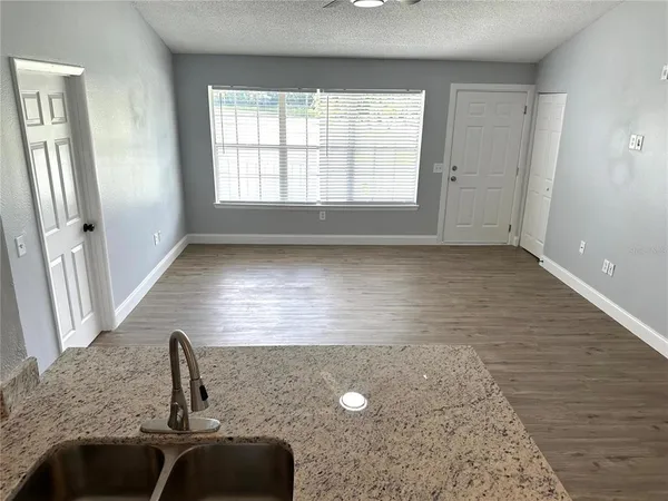 a kitchen with granite countertop a sink and a window
