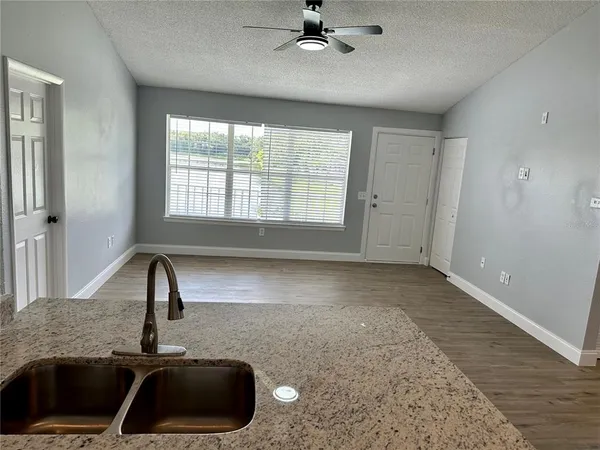 a view of a kitchen with a sink and window