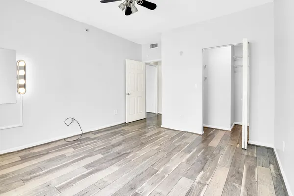 a view of a room with wooden floor and white walls