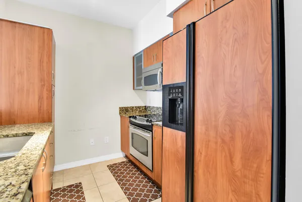 a kitchen with stainless steel appliances granite countertop a stove and a microwave