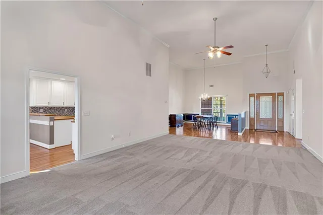 a view of a kitchen with furniture and wooden floor
