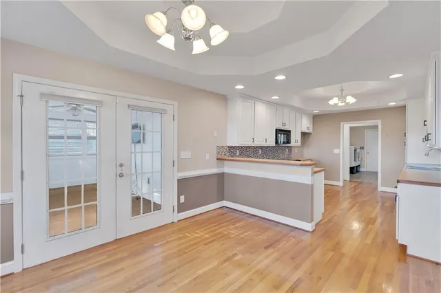 a large kitchen with kitchen island a sink stainless steel appliances and cabinets