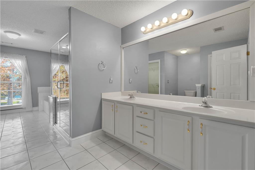 523 Barhams Ridge Drive McDonough, GA 30252 - Photo 20 of 43 a spacious bathroom with a double vanity sink and a mirror
