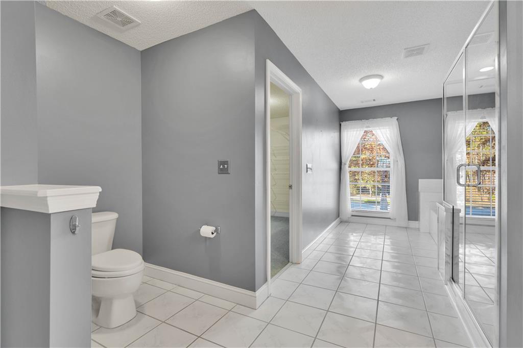 523 Barhams Ridge Drive McDonough, GA 30252 - Photo 21 of 43 a bathroom with a toilet a sink and shower