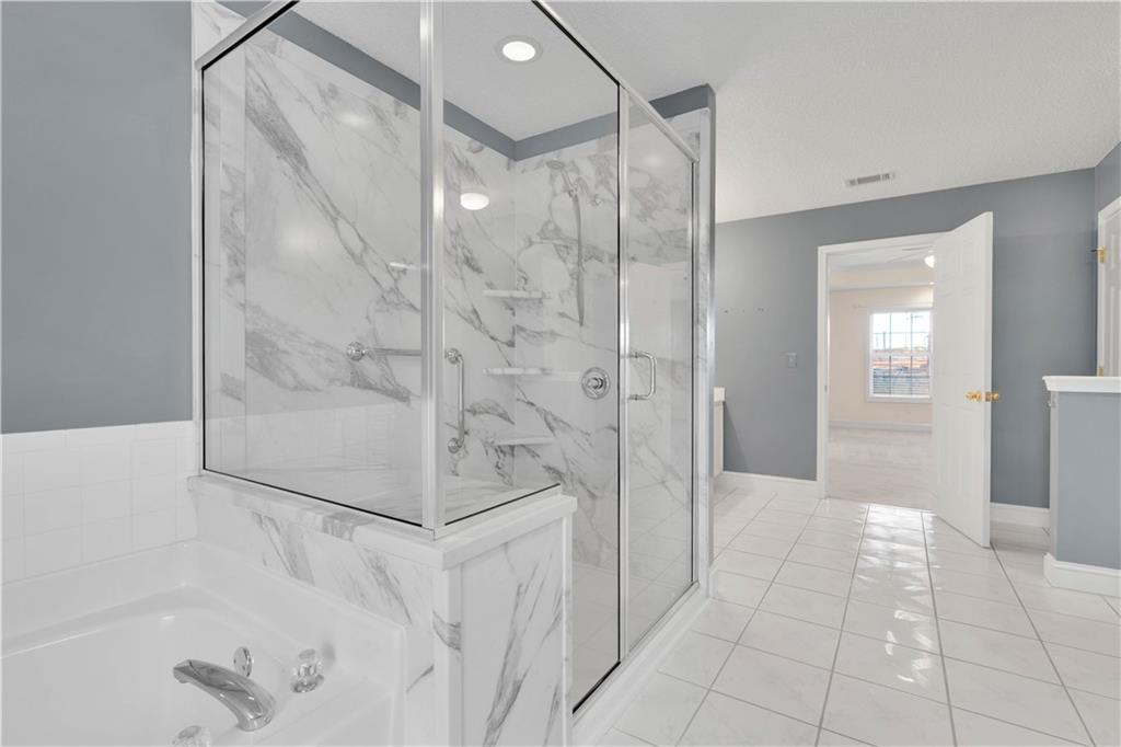 523 Barhams Ridge Drive McDonough, GA 30252 - Photo 23 of 43 a bathroom with a shower and mirror