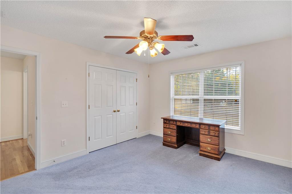 523 Barhams Ridge Drive McDonough, GA 30252 - Photo 24 of 43 an empty room with chandelier fan and windows