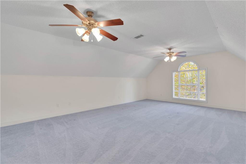 523 Barhams Ridge Drive McDonough, GA 30252 - Photo 33 of 43 an empty room with windows and chandelier fan