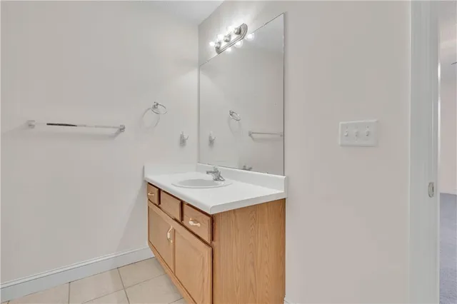 a bathroom with a sink vanity and a mirror