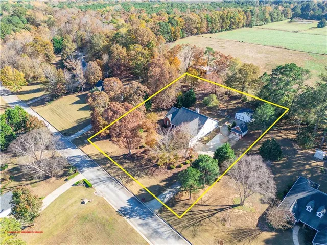 an aerial view of a house with a yard and lake view