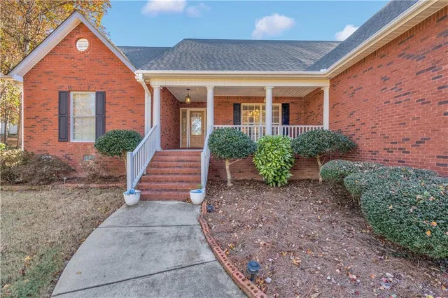 a front view of a house with garden