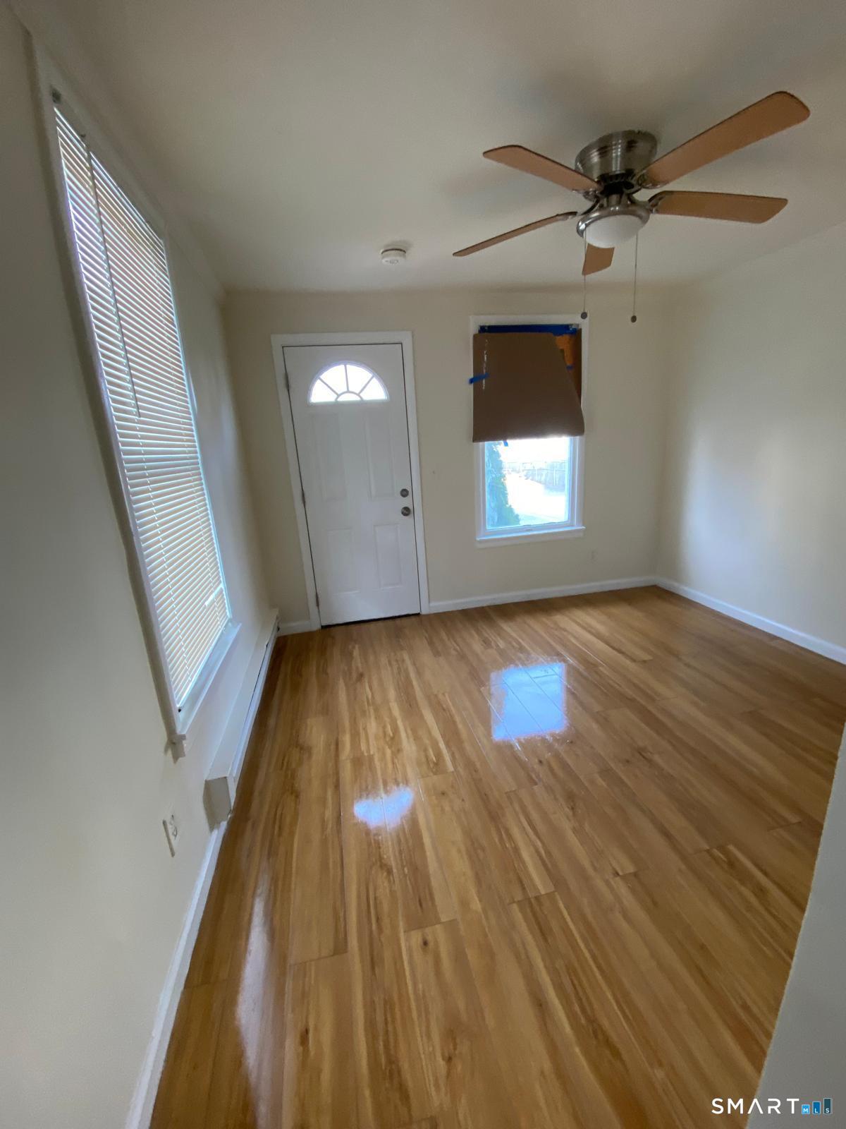 54 North Avenue Meriden, CT 06451 - Photo 5 of 18 wooden floor in an empty room with a window