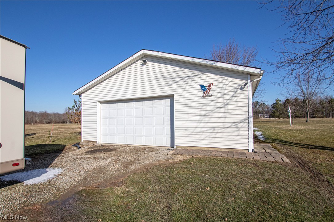 9459 Stone Road Litchfield, OH 44253 - Photo 31 of 50 Garage featuring a yard