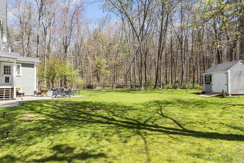 203 Main Street Acton, MA 01720 - Photo 13 of 42 a backyard of a house with lots of green space