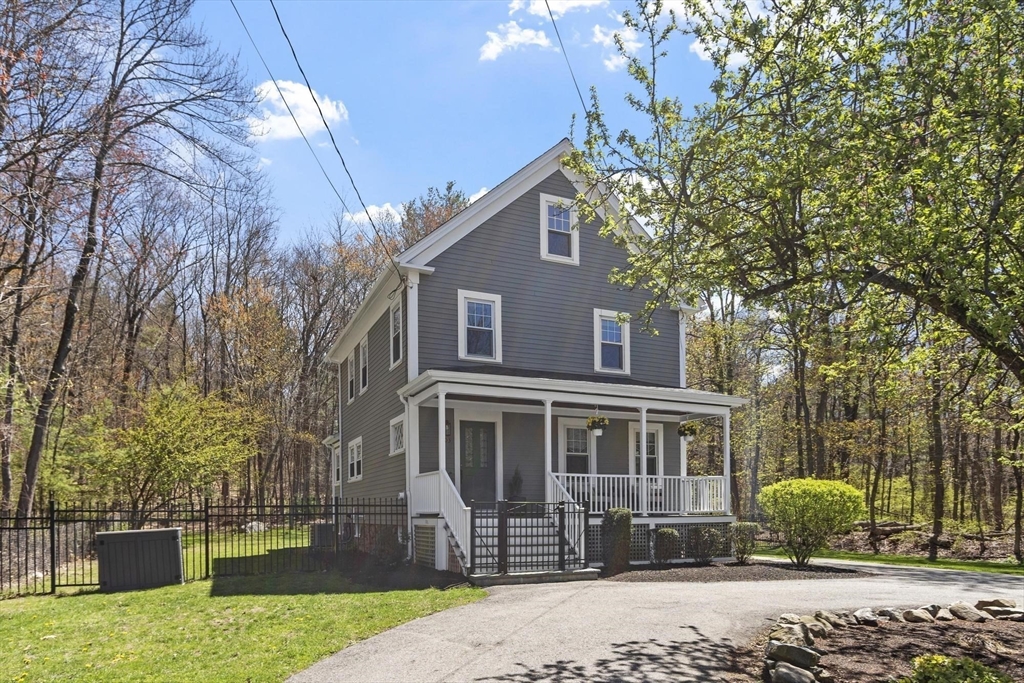 203 Main Street Acton, MA 01720 - Photo 2 of 42 a front view of a house with a yard