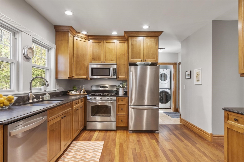 203 Main Street Acton, MA 01720 - Photo 22 of 42 a kitchen with stainless steel appliances granite countertop a refrigerator a stove a sink and a microwave