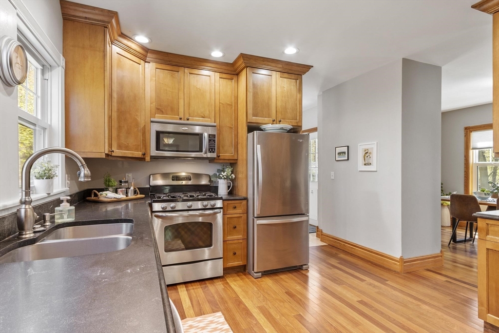 203 Main Street Acton, MA 01720 - Photo 23 of 42 a kitchen with granite countertop a stove a sink and a refrigerator