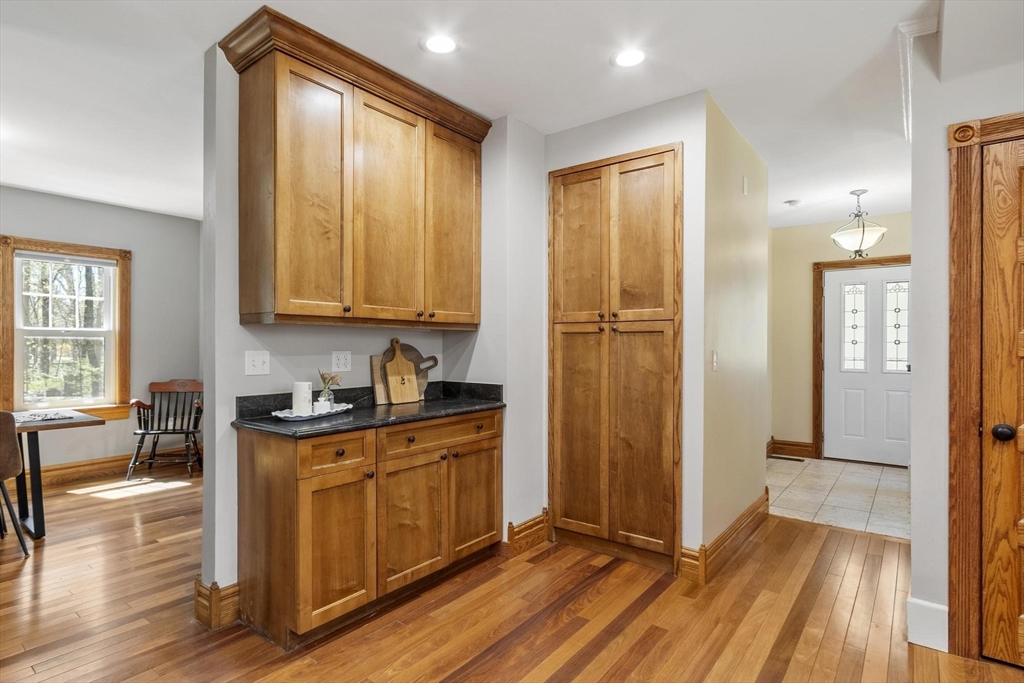203 Main Street Acton, MA 01720 - Photo 24 of 42 a view of a kitchen with stainless steel appliances granite countertop wooden floor and a window