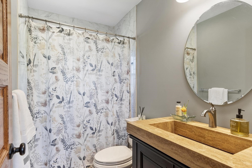 203 Main Street Acton, MA 01720 - Photo 26 of 42 a bathroom with a sink and a mirror
