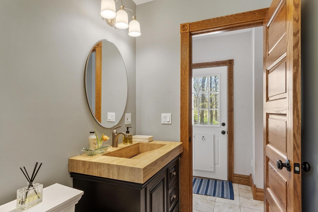 203 Main Street Acton, MA 01720 - Photo 27 of 42 a bathroom with a sink a mirror and a toilet