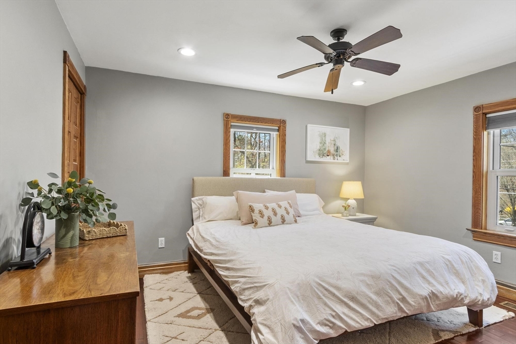 203 Main Street Acton, MA 01720 - Photo 28 of 42 a bedroom with a large bed and a chandelier