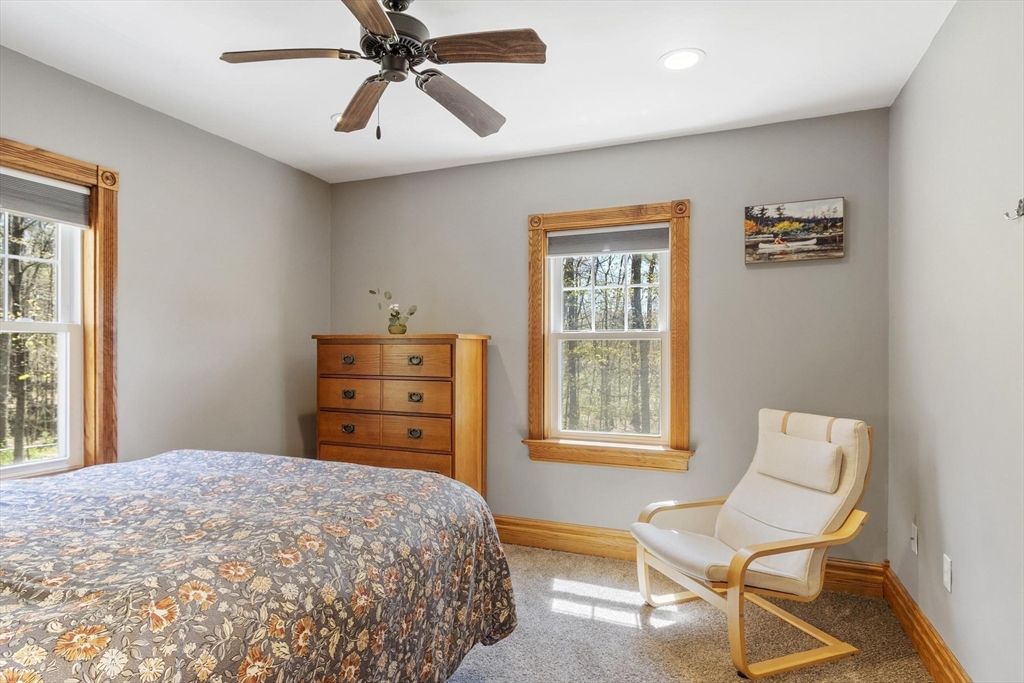 203 Main Street Acton, MA 01720 - Photo 32 of 42 a bedroom with a bed and a chair